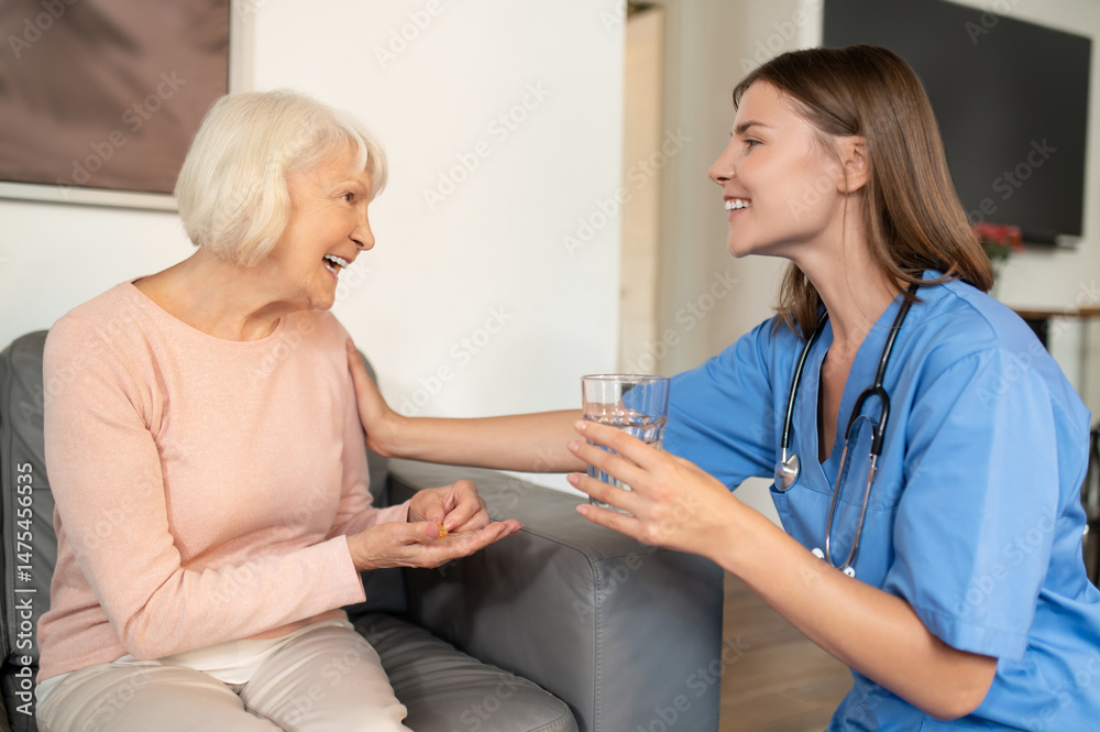 Fototapeta premium Nurse providing healthcare assistance support and care for elderly patient