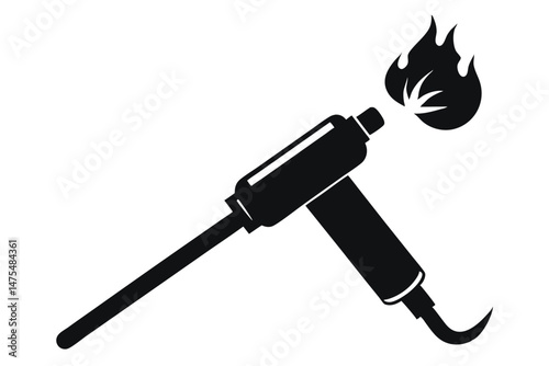 Black welding blow torch with flame indicates metal work process in workshop