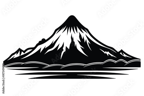 Monochromatic mountain peak rises majestically over small hills and a still lake