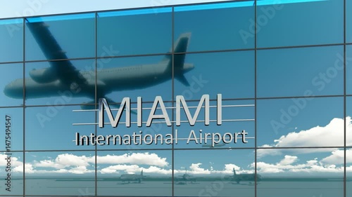 Miami international airport. Plane landing at Miami. Arrival in the city with the glass airport terminal and reflection of the jet aircraft. Travel, business, tourism and transport.	 photo
