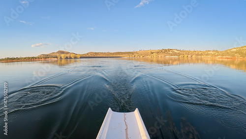 rowing scenery from a calm lake at foothills of Rocky Mountains - rower POV view