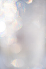 Abstract glowing bokeh background. Grey holiday glow backdrop. Defocused Background With Blinking Stars. Pastel color, monochrome Blurred Bokeh art design. Abstract shiny lights design, wedding