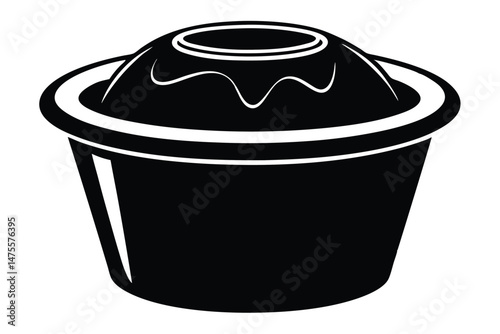 A stylized black dessert rests inside a black cup with white trim outlining it