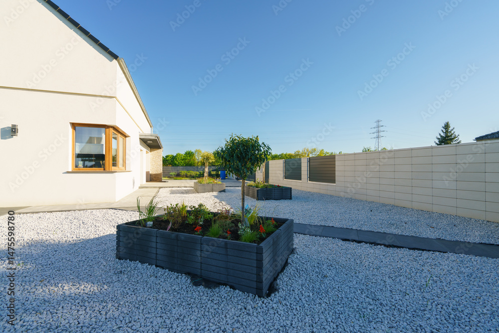 Concrete flowerpots with freshly planted flowers