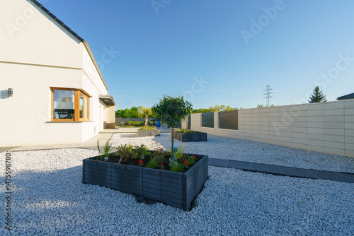 Concrete flowerpots with freshly planted flowers
