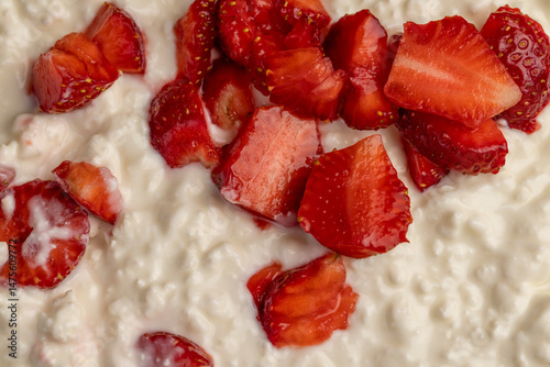 low-calorie cottage cheese with sour cream and fresh red strawberries, white sour-milk cottage cheese with strawberries