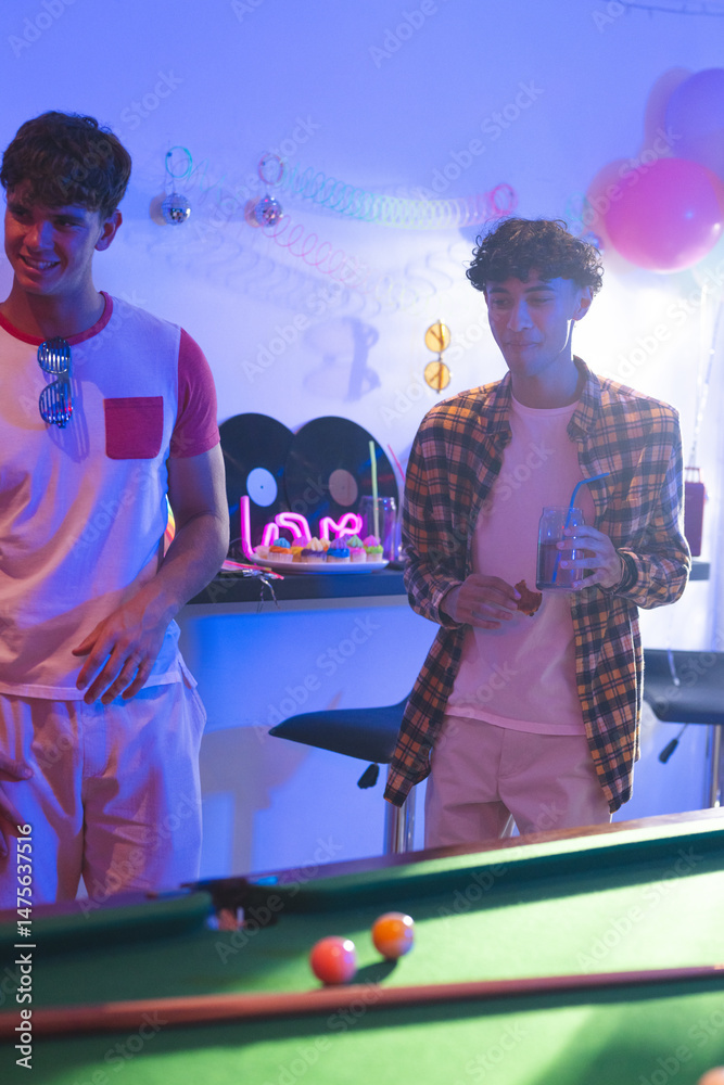 Fototapeta premium Playing lively pool game, teenagers celebrating birthday party with friends