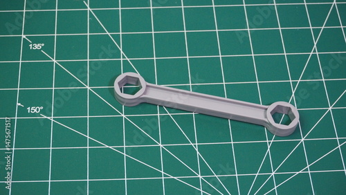 Green cutting mat with measurement grid lines, used for crafting, sewing, DIY projects, and precision cutting work.