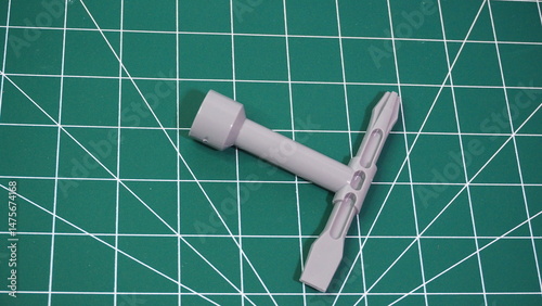 Green cutting mat with measurement grid lines, used for crafting, sewing, DIY projects, and precision cutting work.