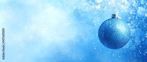Sparkling Blue Christmas Ornament Hanging with Snow and Glitter Background for Winter Holiday Decoration and Festive Celebrations