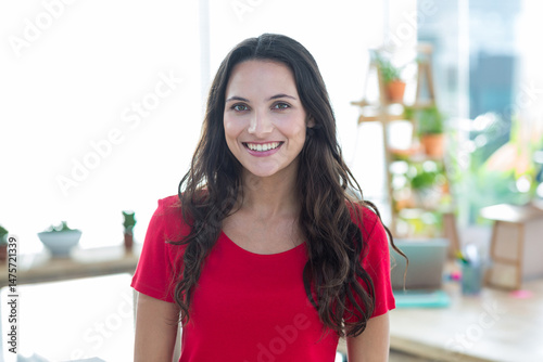 Smiling woman standing in modern home office, with laptop, wooden desk and potted plants Free Download Smiling woman standing in modern home office, with laptop, wooden desk and potted plants - GFXLoad