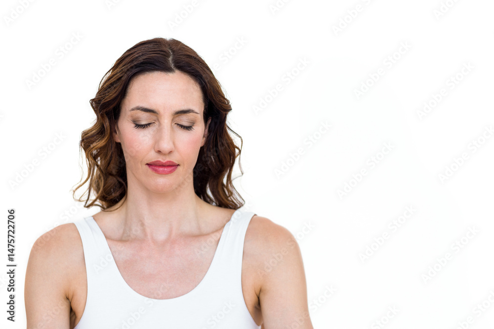 Meditating woman standing with eyes closed in studio with plain white background, serene expression Meditating woman standing with eyes closed in studio with plain white background, serene expression