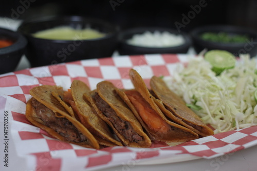 A plate of fresh tacos filled with seasoned meats and vibrant toppings, emphasizing the cultural significance and joy of sharing delicious food in a casual setting.