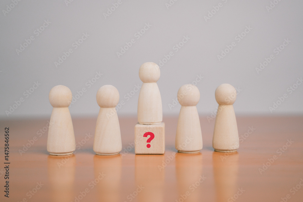 What do the wooden blocks in the question mark on the table mean? Teamwork concept, business, wooden cubes. What do the wooden blocks in the question mark on the table mean? Teamwork concept, business, wooden cubes.