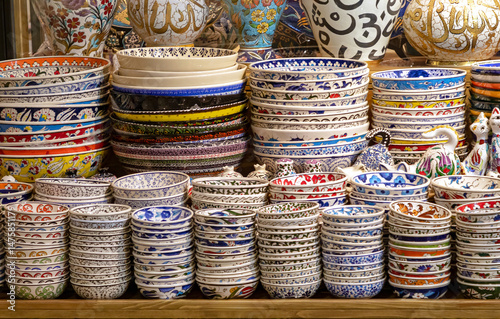 Colorful decorative ceramic bowls sold on market stall outside