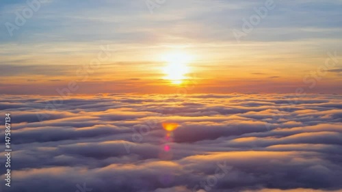 Golden sunrise over a misty landscape. Ideal for nature themes, peaceful visuals, and scenic backgrounds. Warm light, tranquil.