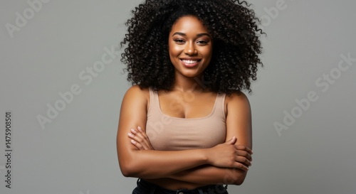 Confident woman smiling with curly hair in casual attire