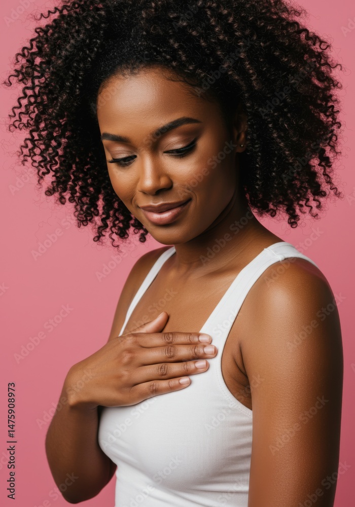 Elegant woman in white tank top on pink background - confidence and beauty concept