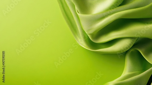 Obraz na płótnie Soft green fabric swirls and drapes elegantly on a bright green backdrop, creating a serene and calming effect w salonie