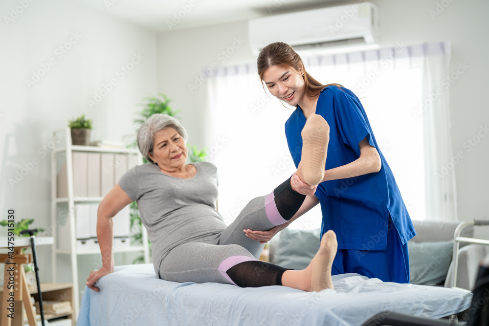 Obraz premium Elderly Asian woman receive physical therapy with support of caregiver. 
