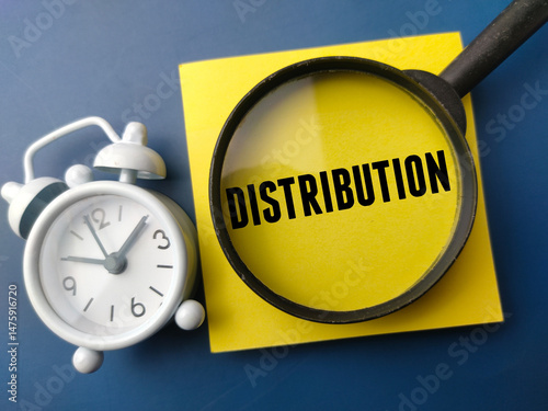 Magnifying glass and alarm clock with the word DISTRIBUTION on a blue background