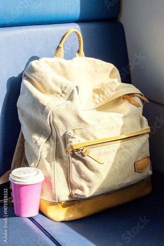Travel Backpack with Coffee Cup on Train Seat. Ready for Trip, Solo Travel, Adventure and Exploration on Journey.