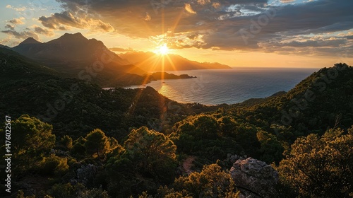 A vivid sunrise over the mountains of PrÃ­ncipe Island, with sunlight casting shadows over the coastal forest and the sparkling ocean in the distance. photo