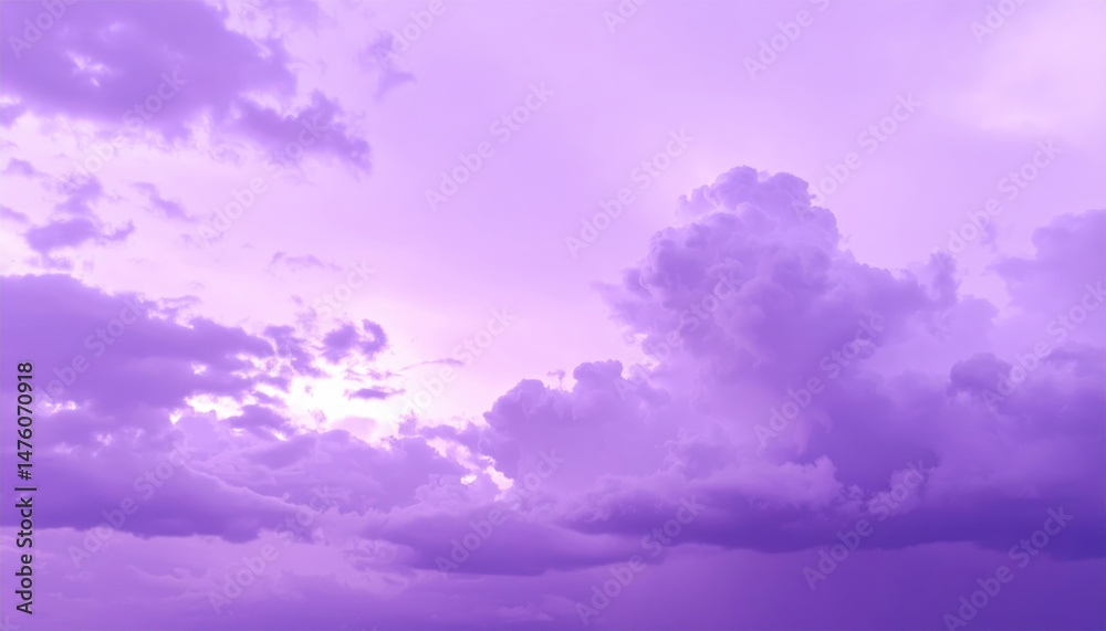 Obraz premium A stunning purple sky adorned with fluffy, soft clouds, creating a dreamy atmosphere as the sun sets, casting a warm glow across the horizon.