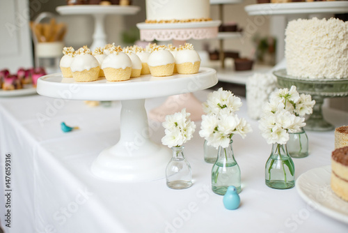 table topped with lots of white cake pops