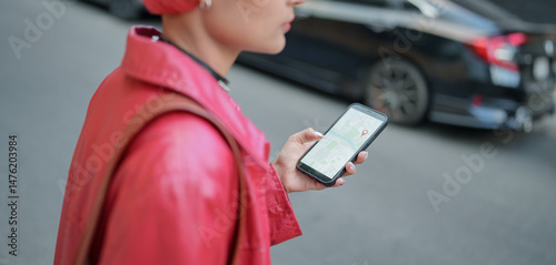 Traveler Gen z girl leather fashion with punk Asian woman tourist in city street searching location in map application online smart phone using GPS navigating