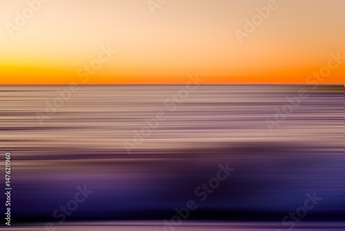 Blurred natural background. Orange sunset sky over blue sea.