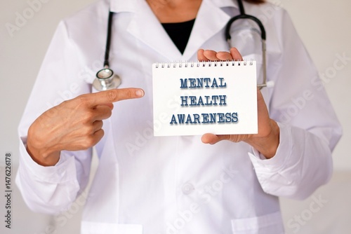 mental health awareness concept. doctor pointing to the words in his notebook