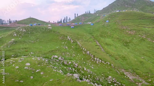 mountain landscape with green grass and clouds
