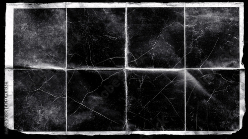 Creased dark paper: A close-up captures a vintage piece of dark paper, worn and creased with intricate patterns of lines and textures, evoking a sense of history and a subtle tactile experience.