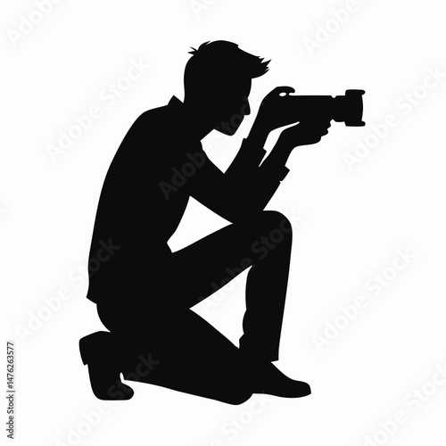 Silhouette of Photographer Kneeling, Taking Photo