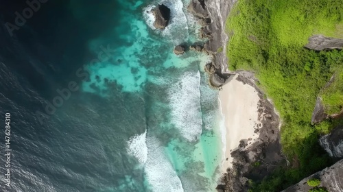 Stunning drone shot of Uluwatu Beach, Bali, featuring turquoise waters, rugged cliffs, and rocky coastline. Ideal for nature travel and landscape projects.
