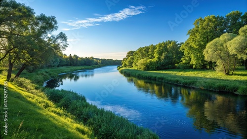 A serene river landscape under a clear blue sky during daytime hours