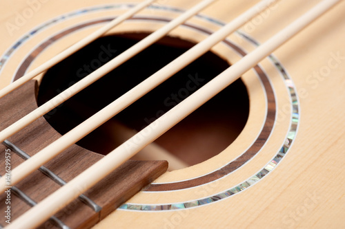 Four-string bass ukulele with wooden body and built-in tuner and pickup.