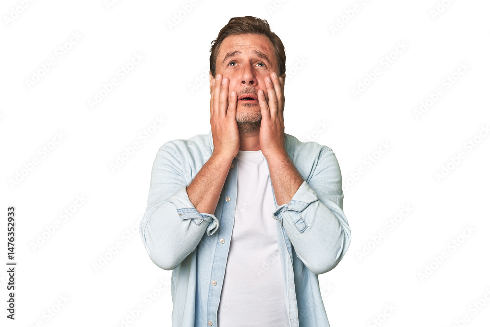 A middle-aged man isolated whining and crying disconsolately. A middle-aged man isolated whining and crying disconsolately.