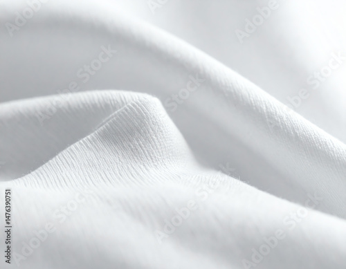 Soft, white fabric drapes gently, showcasing delicate textures and smooth surfaces, creating a serene and elegant visual appeal