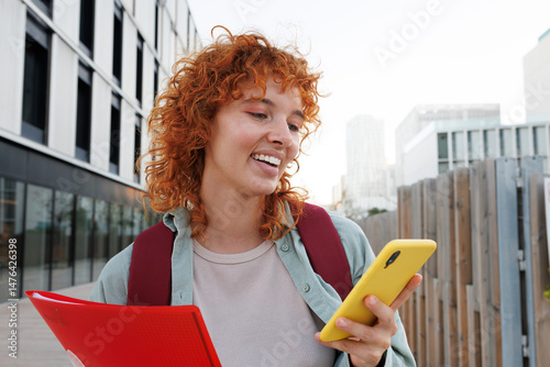 Photography Young student engaging with smartphone outdoors