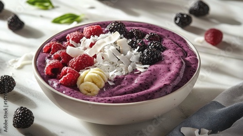 A beautifully arranged smoothie bowl, bursting with fresh berries and tropical fruit, is ready to enjoy.
