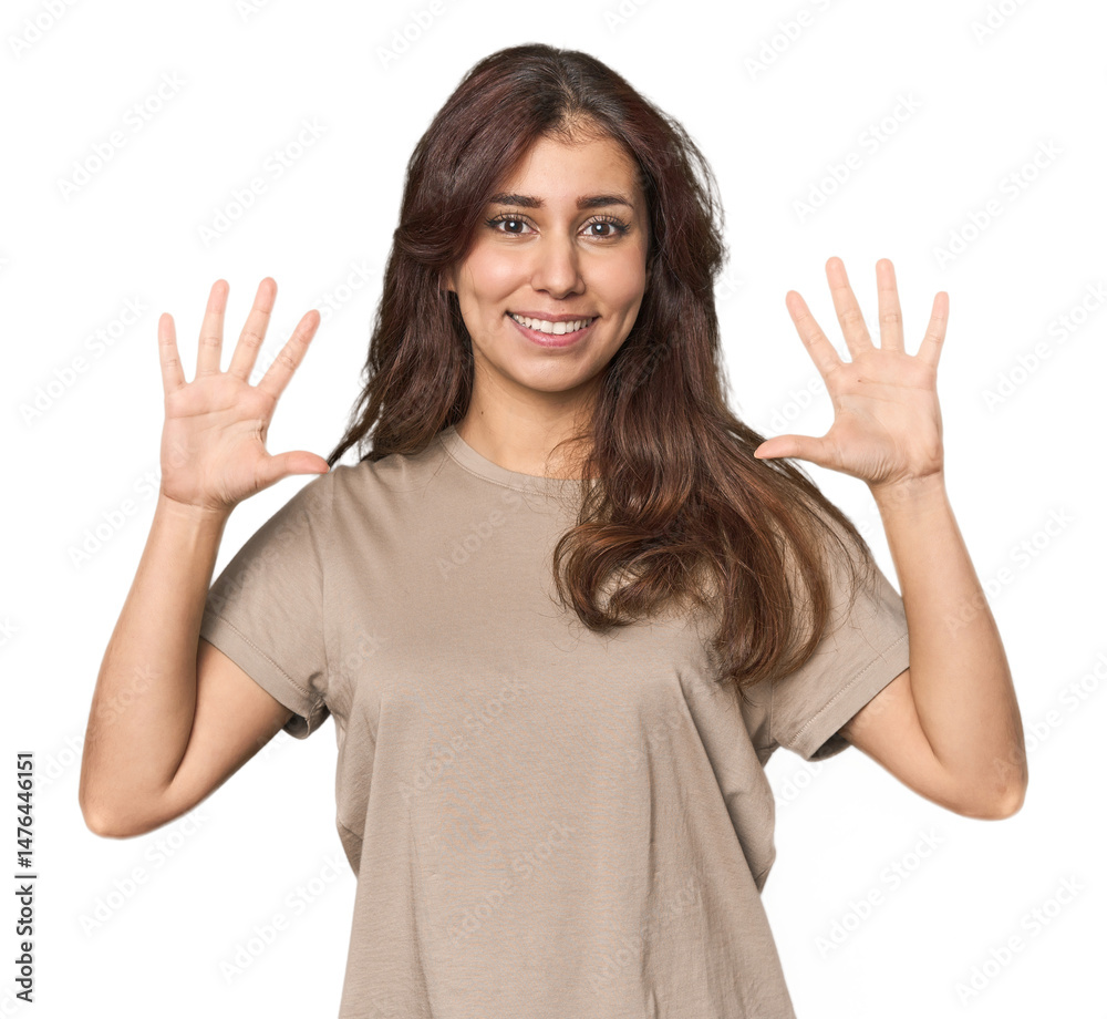 Middle Eastern woman in studio showing number ten with hands. Middle Eastern woman in studio showing number ten with hands.