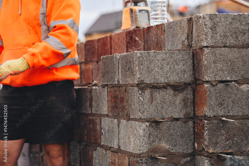Fototapeta premium Close-up of Construction worker laying concrete blocks on building site