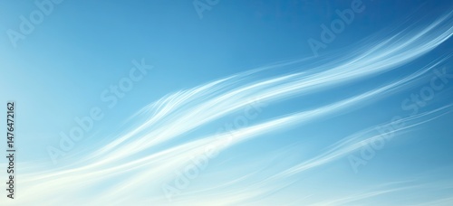 Wispy clouds flowing across a vibrant blue sky