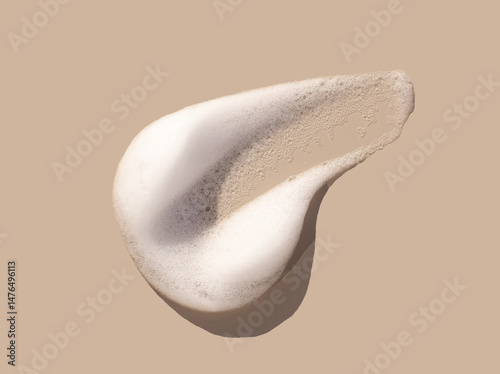 texture foam mousse foam cosmetic smear sample on beige background photo