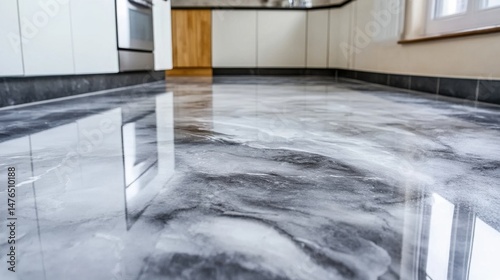 Modern kitchen interior featuring a polished gray epoxy floor with marble effect at eye level view