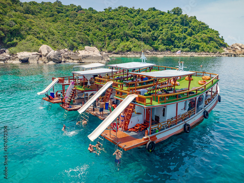 Top aerial view of  natural bay serving ton of traveler tourist  take bundle of tour boats dropped anchorage let people enjoy water sport together  in summertime Thailand travel and visiting