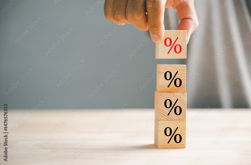 © sorapop - Concept of interest rate and mortgage rates. Hand positioning a wooden cube block that represents growth and an upward direction, accompanied by a percentage symbol. © sorapop - Concept of interest rate and mortgage rates. Hand positioning a wooden cube block that represents growth and an upward direction, accompanied by a percentage symbol.