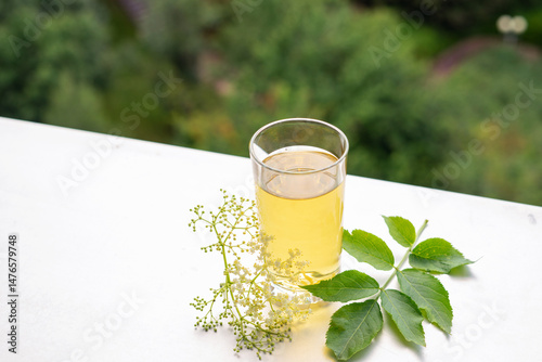 Summer iced elderflower tea on the table